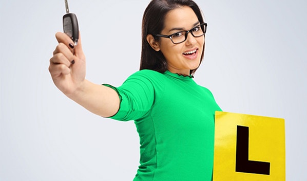 Learner driver wearing green holding keys
