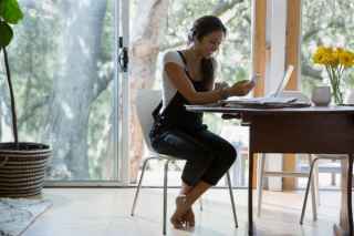woman on laptop sitting at table