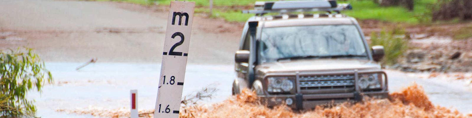 car driving into flooded road