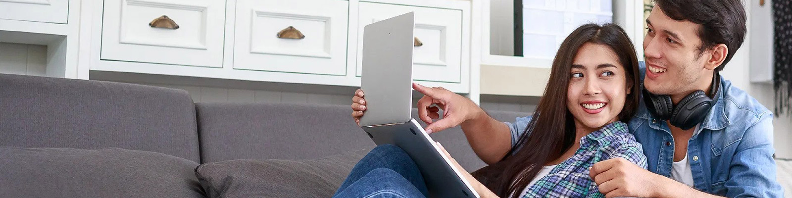 couple using computer on couch