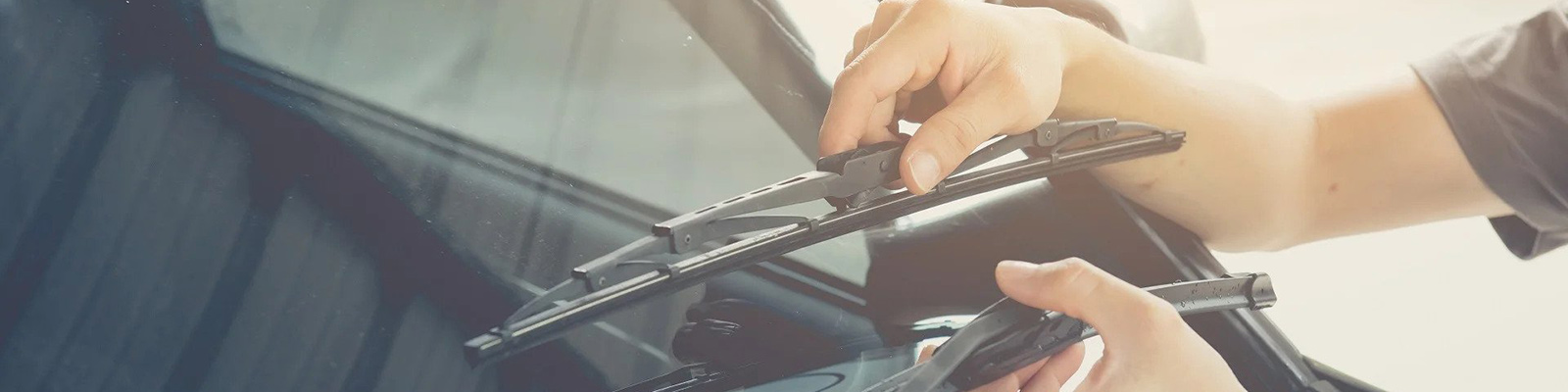 hands raising car window wipers
