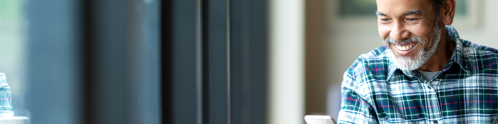 man looking at smartphone and smiling