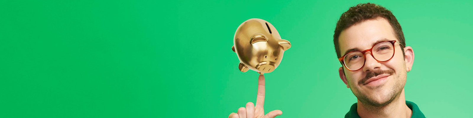 man smiling with a golden piggy bank