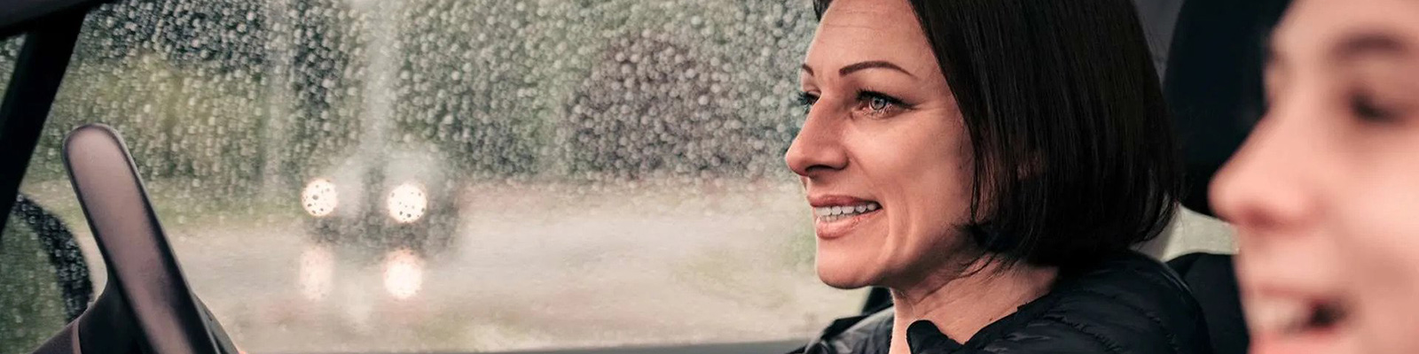 mother daughter driving in rain