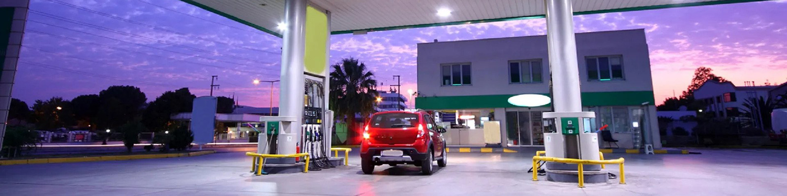 red car in petrol station