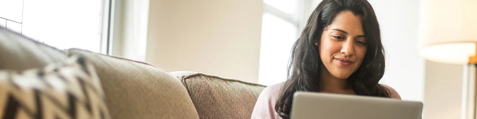 woman using laptop computer on couch