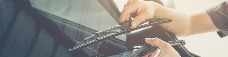 hands raising car window wipers