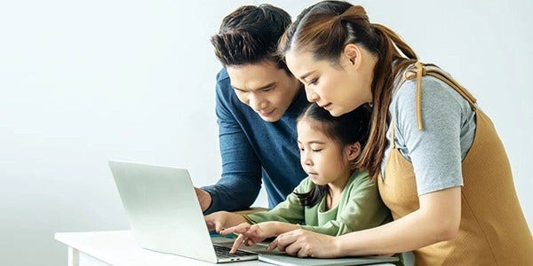 Man woman and young girl looking at laptop