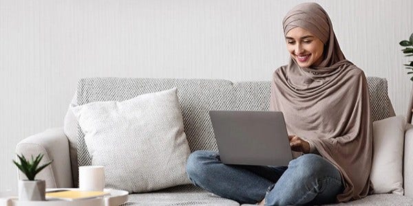 Lady on couch with laptop