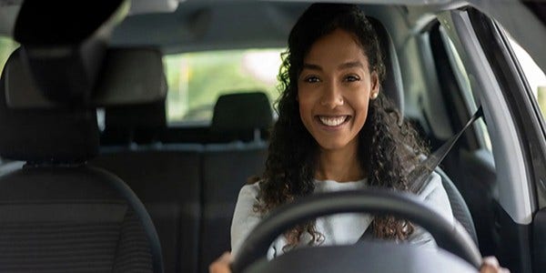 Young girl driving smiling